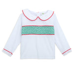 White blouse with red trim and green pattern on a white background