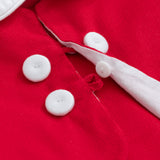 Close-up of a red garment with white buttons and trim