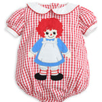 A baby short-sleeve romper in a red and white gingham pattern, featuring a Raggedy Ann doll applique on the front, complete with a white Peter Pan collar and white cuffs.
