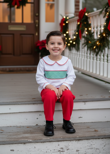 Child sitting on a porch decorated for Christmas with wreaths and lights.